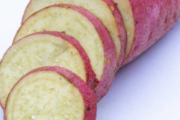 Sliced of sweet potatoes on white background close-up view