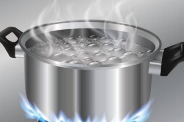 Stainless steel pot boiling water. On the gas stove.